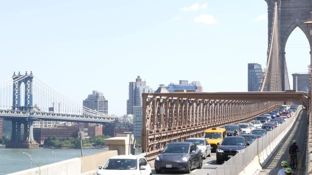 New York City, United States - 3 Sept 2023: Cars on Brooklyn Bridge, Manhattan Bridge view. Yellow taxi cab, rush hour road traffic jam and architecture. Iconic landmark on East River. Travel USA.