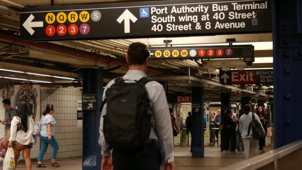New York City, United States - 31 Aug 2023: Manhattan subway station interior, underground metropolitan transfer. Public metro transport. Railway change hub, passenger traffic junction. People in NYC.