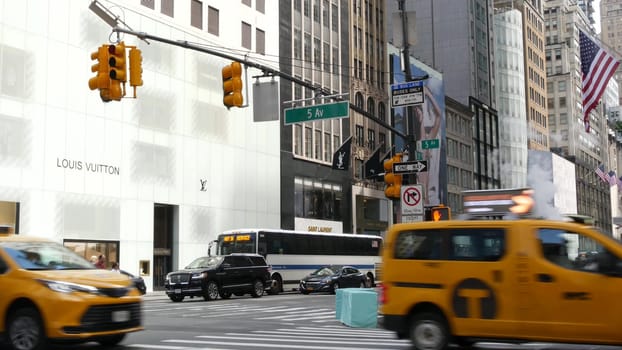 New York City, United States - 13 Sept 2023: Manhattan Midtown street, Fifth 5 avenue. American urban road car traffic. Yellow taxi in USA. People. Boutique fashion stores for shopping. Louis Vuitton