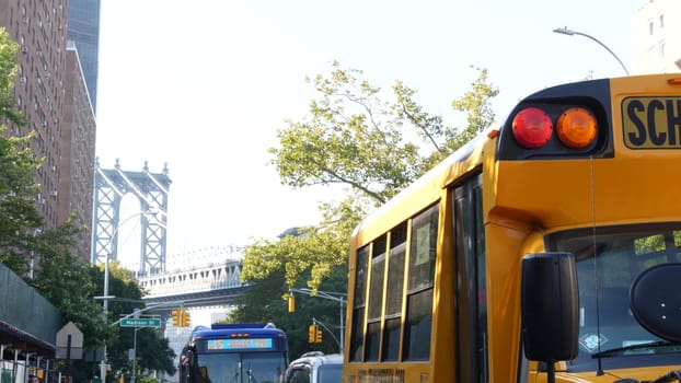 New York City, United States - 7 Sept 2023: Yellow School Bus, Manhattan bridge, schoolbus truck, city street. Children education and USA transportation. American residential district school shuttle.