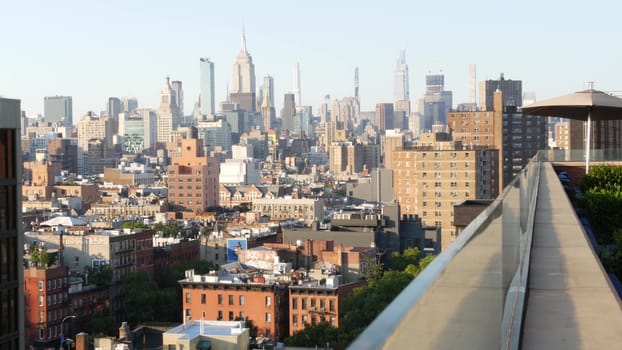 New York City, United States - 7 Sept 2023: Manhattan skyline cityscape. Empire State Building. Rooftop, residential house roof. Real Estate, urban street architecture, Midtown district, East Village.