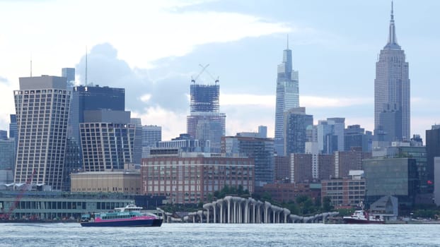 New York City, United States - 11 Sept 2023: Waterfront skyline, Manhattan Midtown Empire State Building, riverfront skyscrapers architecture. Little Island. Waterside cityscape, Hoboken, New Jersey.