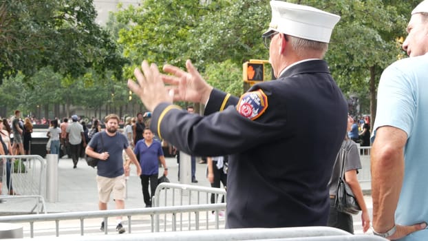 New York City, United States - 11 September 2023: Firefighters celebrate Patriot Day. FDNY officer near 911 Memorial Pools. Fire department old fireman talking to people on Manhattan Downtown, USA.