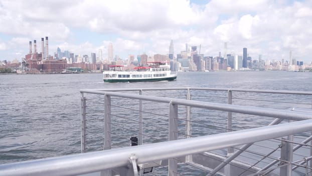 New York City, United States - 30 Aug 2023: Manhattan midtown skyline, ferry boat. Highrise skyscrapers from ferryboat. East river waterfront architecture near water. Empire State, Chrysler Building.