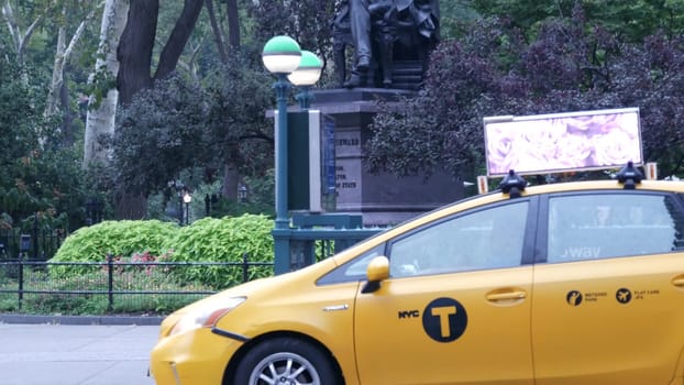 New York City, United States - 8 Sept 2023: Manhattan Midtown Broadway, 23 street, 5 avenue crossroad intersection. Madison Square Park by Flatiron Building, USA. People, subway and yellow taxi. Rain.