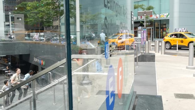 New York City, United States - 11 Sept 2023: Manhattan Midtown Lexington avenue, United States. People pedestrian exit underground subway station, stairs on 53 street, urban USA. Metro entrance sign.
