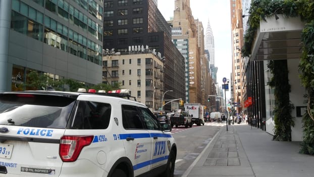 New York City, United States - 11 Sept 2023: Police patrol car, USA NYPD, 911 vehicle, Manhattan Midtown street traffic. American cop auto on Lexington avenue. Urban road transport. Chrysler Building.