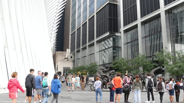 New York City, United States - 10 Sept 2023: Manhattan Downtown Financial District street. People near World Trade Center Oculus. USA architecture. Wildlife art sculpture, animals on bike installation