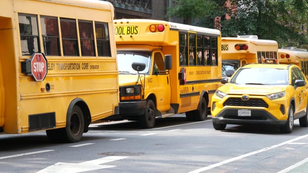 New York City, United States - 8 Sept 2023: Row of yellow school bus truck, Manhattan street road. USA children education and transportation. American shuttle near Presbyterian Church, Fifth 5 avenue.