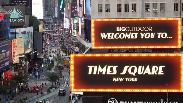 New York City, United States - 14 Sept 2023: Times Square, Manhattan Midtown Broadway street, USA. American NYC urban road traffic, people from above. Commercial illuminated billboard screens glowing.