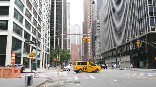 New York City, United States, 9 Sept 2023: Manhattan Downtown Financial District Water street crossroad intersection. USA city life. Urban road car traffic. Yellow taxi. People pedestrian. Smoke stack