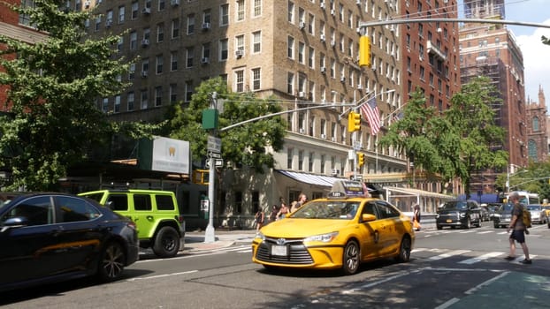 New York City, United States - 8 Sept 2023: Manhattan Greenwich Village street, 5th, Fifth 5 avenue. American urban road car traffic. Yellow taxi cab in USA. Empire State building and Forbes
