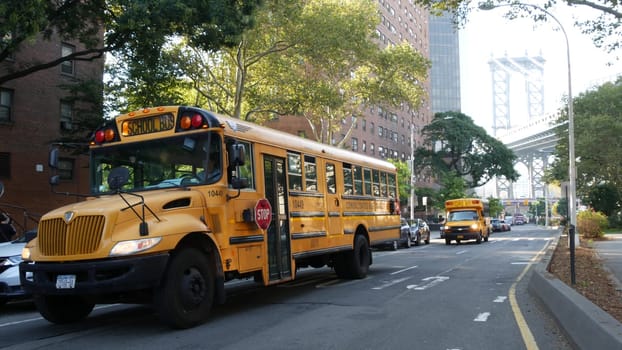 New York City, United States - 7 Sept 2023: Yellow School Bus, Manhattan bridge, schoolbus truck, city street. Children education and USA transportation. American residential district school shuttle.