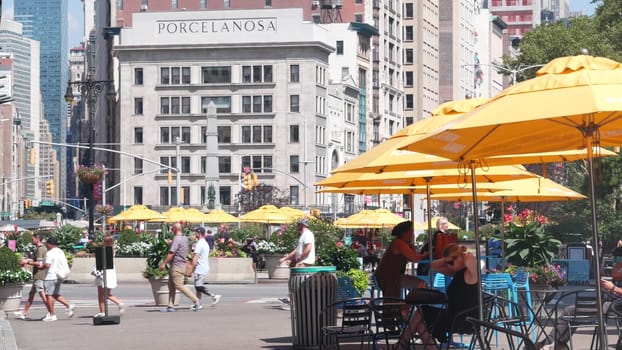 New York City, United States - 6 Sept 2023: Manhattan Midtown Broadway, 23 street, 5 avenue crossroad intersection. Worth Square near Madison Park, Flatiron, USA. Porcelanosa. People on chairs, tables
