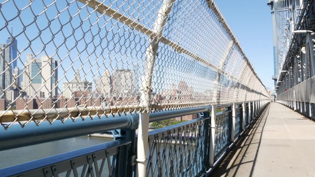 New York City, United States - 14 Sept 2023: Manhattan Bridge to Brooklyn Dumbo. USA travel destination, tourist landmark. Cable-stayed bridge. Pedestrian path perspective. Downtown skyline cityscape.