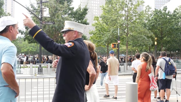 New York City, United States - 11 September 2023: Firefighters celebrate Patriot Day. FDNY officer near 911 Memorial Pools. Fire department old fireman talking to people on Manhattan Downtown, USA.