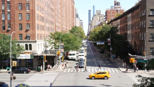 New York City, United States - 1 Sept 2023: Chelsea urban architecture from High Line, Manhattan Midtown street, 10 avenue. American red brick residential buildings, cars traffic on road, yellow taxi.