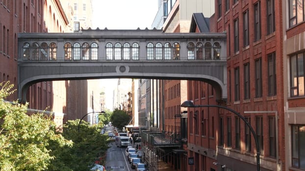 New York City, United States - 1 Sept 2023: Chelsea Market skybridge. Industrial architecture, red brick building. Elevated sky bridge, Manhattan landmark, USA. Meatpacking district street, High Line.