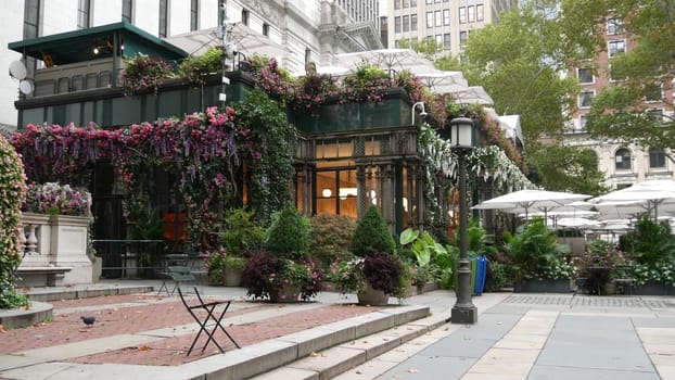 New York City, United States - 13 Sept 2023: Manhattan Midtown Bryant Park with Public library, 42 street and 5th Fifth 5 avenue. USA landmark. Summer cafe greenery, garden flowers bloom and building.