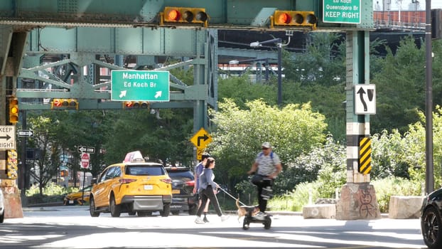 New York City, United States - 2 Sept 2023: Elevated subway over city street. Metropolitan bridge over road, Queens. Long Island overhead metro line, United States. Car under railway track. Queensboro