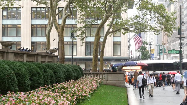 New York City, United States - 13 Sept 2023: Manhattan Midtown, Fifth 5 avenue. 42 street intersection corner near Bryant Park and Library, USA. American urban traffic, people pedestrian on rainy day.