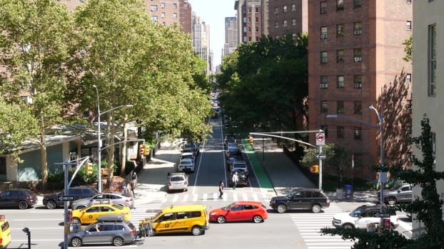 New York City, United States - 1 Sept 2023: Chelsea urban architecture from High Line, Manhattan Midtown street, 10 avenue. American red brick residential buildings, cars traffic on road, yellow taxi.