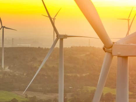 Wind farm field and sunset sky. Wind power. Sustainable, renewable energy. Wind turbines generate electricity. Sustainable development. Green technology for energy sustainability. Eco-friendly energy.