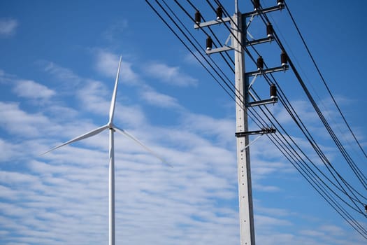 Electricity transmission pylon. Transmission tower collect electricity from wind turbines for sustainable energy. Clean power. Renewable energy infrastructure. Electricity high-voltage lines.