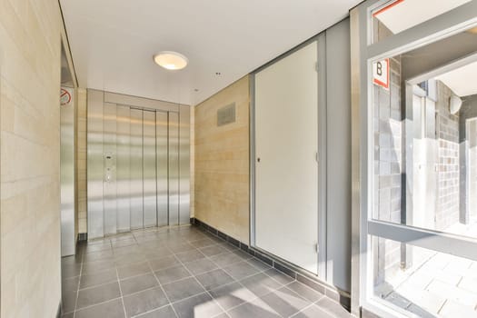 A sleek, modern indoor elevator lobby featuring smooth surfaces, minimalist design, and bright lighting that creates an inviting atmosphere.