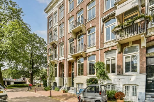 A picturesque scene showcasing classic European architecture, featuring detailed brickwork, balconies, and lush greenery lining a tranquil street.