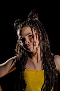 A stylish and fashionable model elegantly showcases a striking and eyecatching hairstyle against a dark backdrop