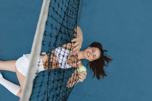 Joyful female tennis player enjoying a moment on the court, dressed in athletic wear, showcasing a vibrant and energetic atmosphere perfect for sports themed content