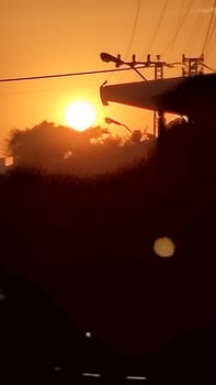 Sunset power lines orange black night dark landmark background . High quality photo