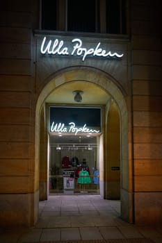 Dresden, Germany – January 17, 2025: Store of the german fashion company Ulla Popken, supplier for plus sizes in the city center of Dresden at night