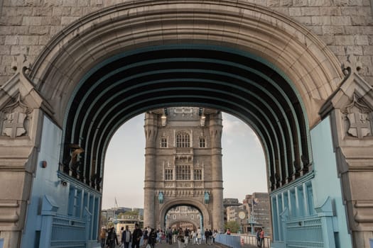 London, UK - Apr 27, 2025 - Crowd of people visit Stunning view of The Iconic Tower Bridge with sky in the background. Famous Tower Bridge is Bascule bridge in London, use it as your Wallpaper, Poster and Copy space, Selective focus.