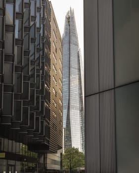 London, UK - Apr 27, 2025 - Perspective of Alley with The Shard skyscraper and some of the modern glass buildings exterior in more london riverside. use it as your Wallpaper, Poster and Space for text, Selective focus.