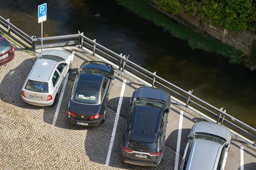 Karlovy Vary, Czech Republic – April 20, 2025: Public parking lot at the river Tepla in the city center of Karlovy Vary in the Czech Republic seen from above