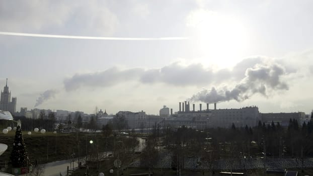 Industrial smokestacks emitting large plumes of smoke over moscow skyline, a concerning scene of urban pollution