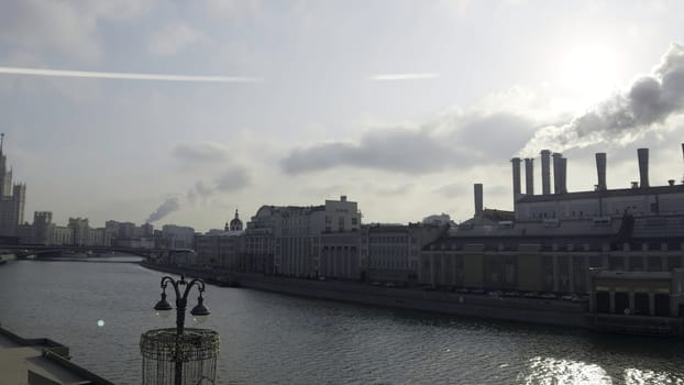 Industrial landscape of moscow with power plant chimneys emitting smoke over moskva river