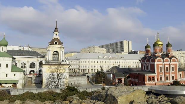 Urban landscape featuring zaryadye park with its scenic overlooks showcasing historic churches and modern buildings under a bright sky
