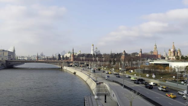 Cars driving along the moskva river embankment near the kremlin in central moscow