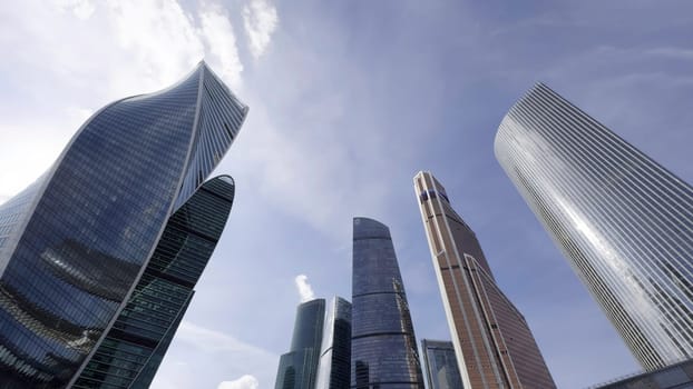 Modern skyscrapers reflecting blue sky and clouds in moscow city business district