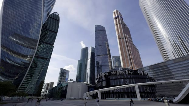 Modern skyscrapers reflecting blue sky and clouds in moscow city business district