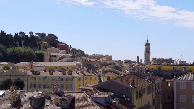 Cityscape of grasse, france, featuring tile roofs and a clear blue sky
