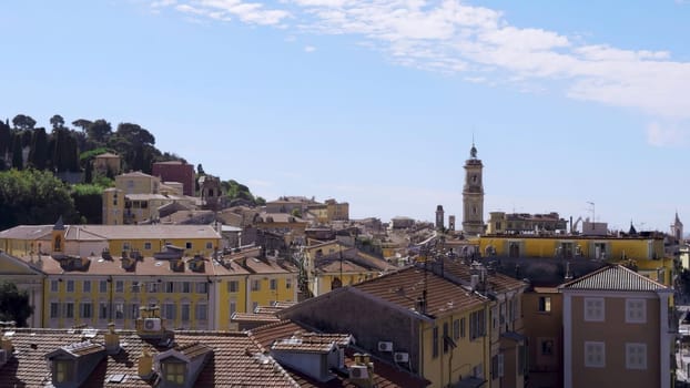 Cityscape of grasse, france, featuring tile roofs and a clear blue sky