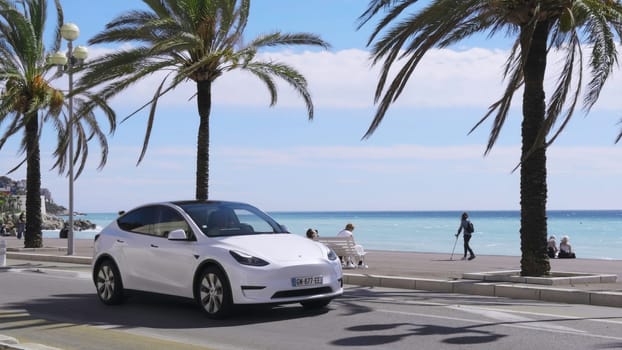 Modern electric car driving on the french riviera, near the mediterranean sea