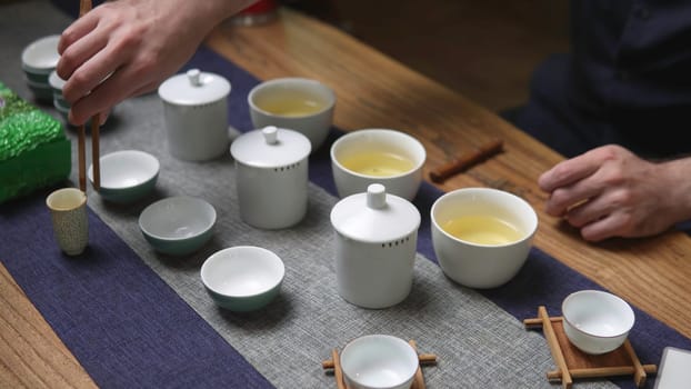 Immerse yourself in a serene and peaceful tea ceremony that features delicate teacups and natural elements. Media