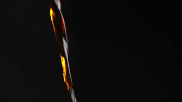 A stunning and captivating visual showcasing a graceful fluid movement that beautifully contrasts with a dark backdrop. Media