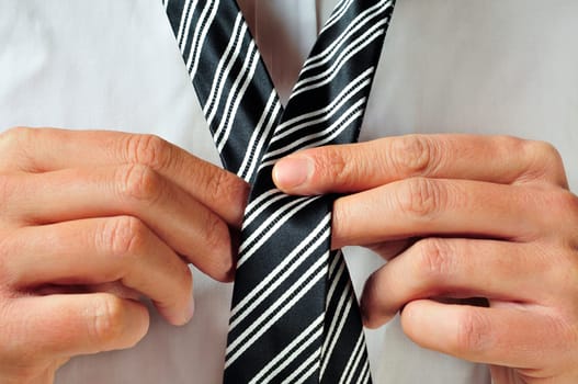 a man knotting his tie