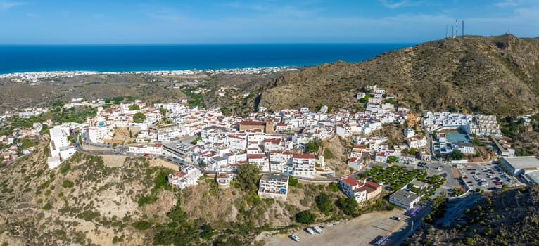 Picturesque spanish hillside white washed village of Mojacar during sunny day against blue sky. Travel destinations, famous places. Europe, southern Spain great panoramic view